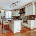 Brown and Tan Kitchen/Living space with the Stratford 4-Light Track Lighting Kit hanging above the island counter