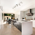 White and charcoal grey Kitchen with the Osgoode Track Lighting Kit hanging above the island counter