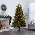 Durand Pine Christmas Tree with Warm White Lights, in Living Room In Front of Fireplace. Fireplace Decorated with Garland and Wreath Above on Wall, Giftboxes to Right of the Tree on Ottoman.