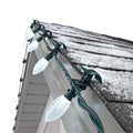 NOMA C9 LED Christmas String Lights Quick Clip™ 25 Bulb - Pure White on a peaked roof line in day time