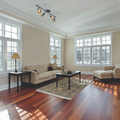 Brown and white living room with the Stratford 4-Light Track Lighting Kit hanging above the couch