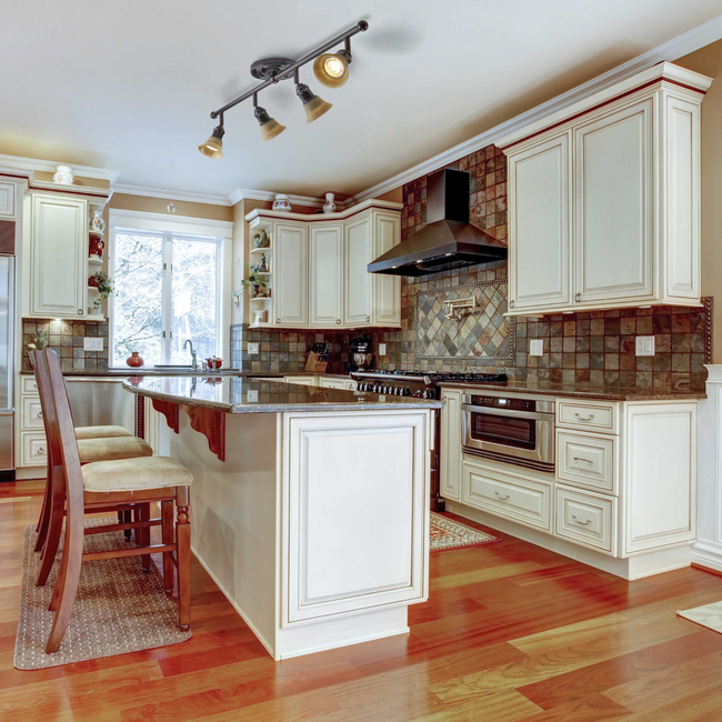 Brown and Tan Kitchen/Living space with the Stratford 4-Light Track Lighting Kit hanging above the island counter 