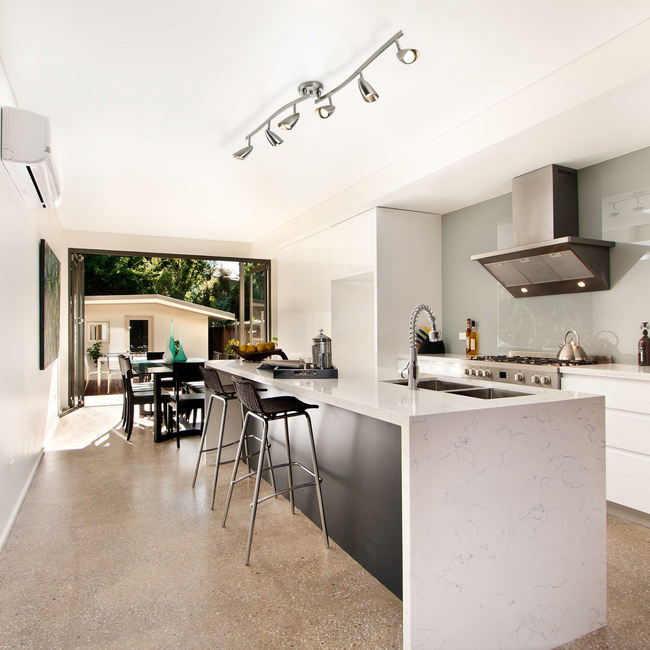 White and charcoal grey Kitchen with the Osgoode Track Lighting Kit hanging above the island counter 