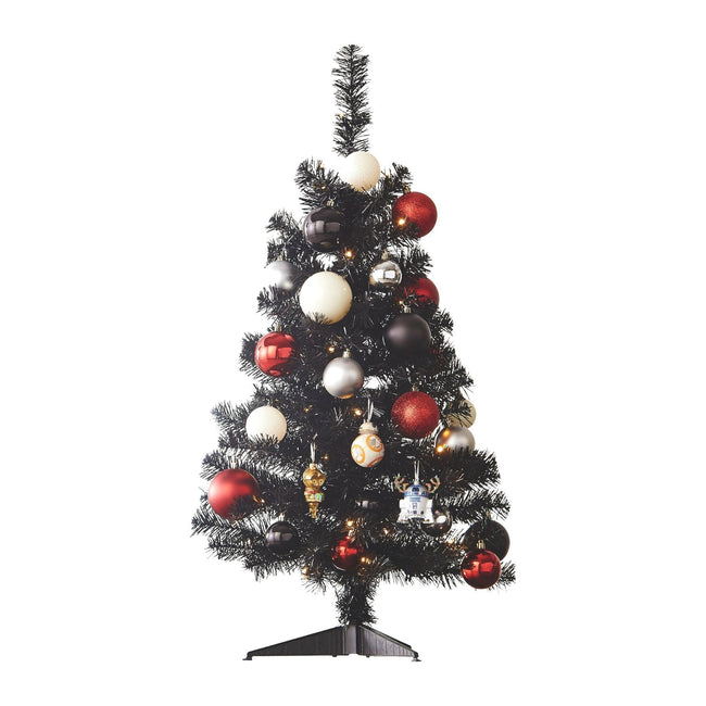 Black Table Top Tree Decorated with Red & White Christmas Ornaments and Baubles. White Background