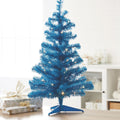 Blue Table Top Tree with Warm White Lights indoors placed on Table with Wrapped Presents 